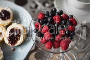 High angle view of berry fruits in bowl on table