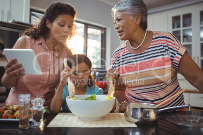Happy family preparing food in kitchen