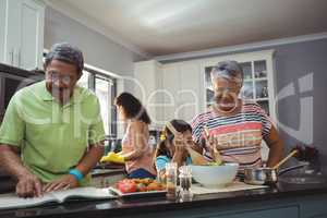 Happy family preparing food in kitchen