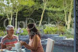 Mother and daughter having tea