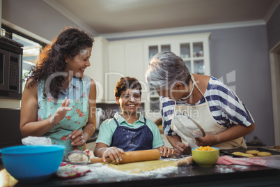 Family preparing dessert in kitchen