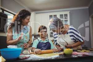 Family preparing dessert in kitchen