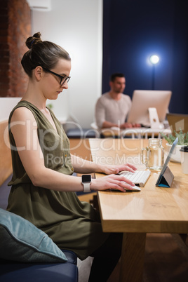 Female executive using digital tablet at desk