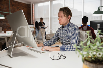 Male executive working on computer in office