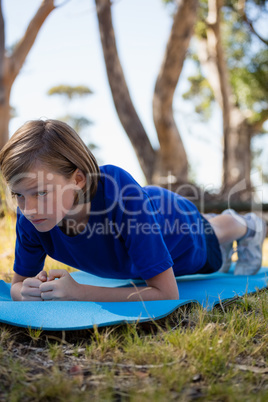Girl exercising on exercise mat during obstacle course training