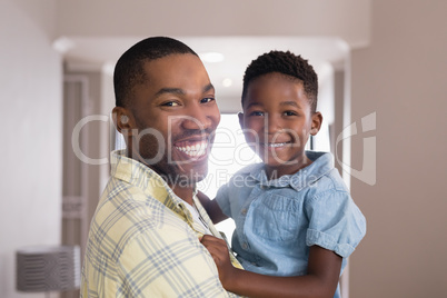 Happy father and son in living room at home