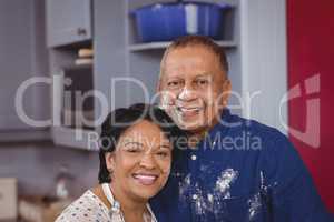 Portrait of mature couple standing in kitchen