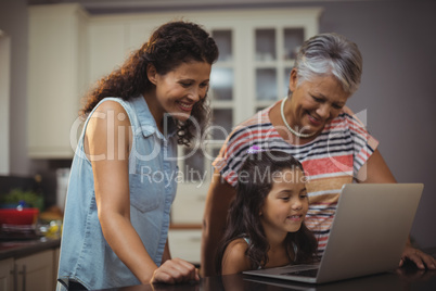 Happy family using laptop in kitchen Happy family using laptop in kitchen