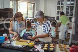 Family preparing dessert in kitchen