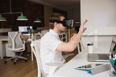 Male executive using virtual reality headset