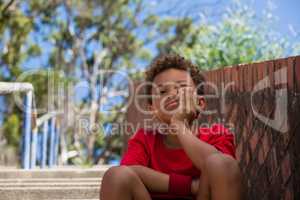 Upset boy sitting on staircase in the boot camp