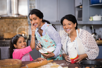 Portrait of cheerful multi-generation family preparing food together