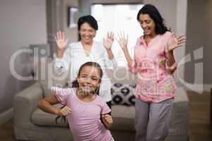 Portrait of smiling girl dancing with family