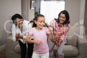 Happy multi-generation family dancing together