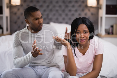 Young couple arguing while sitting at home