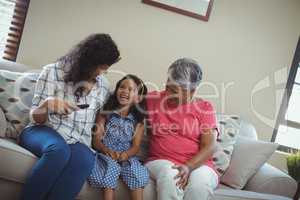 Smiling family watching television together in living room