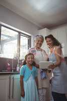 Happy family using digital tablet in kitchen