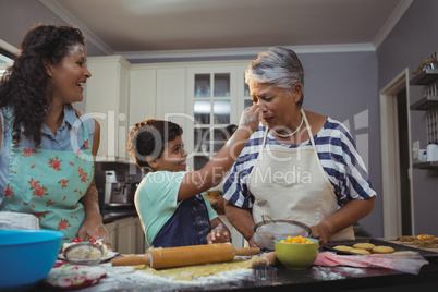 Family preparing dessert in kitchen