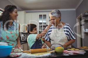 Family preparing dessert in kitchen