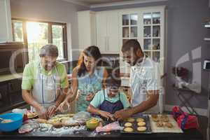 Happy family preparing dessert in kitchen
