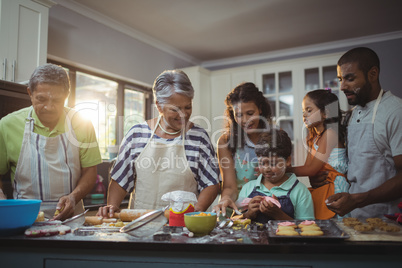 Happy family preparing dessert in kitchen