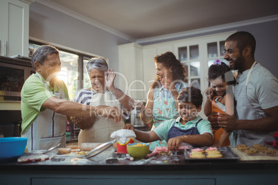 Happy family preparing dessert in kitchen