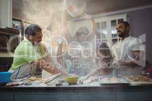 Happy family preparing dessert in kitchen