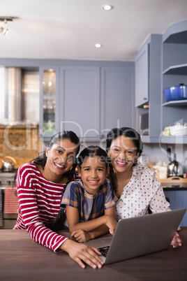 Portrait of happy multi-generation family in kitchen