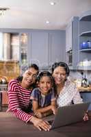 Portrait of happy multi-generation family in kitchen