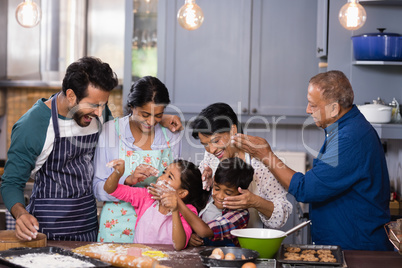 Happy multi-generation family enjoying together in kitchen