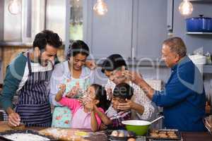 Happy multi-generation family enjoying together in kitchen