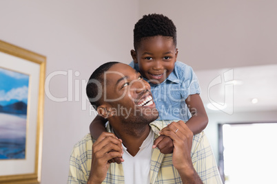 Boy playing with father at home