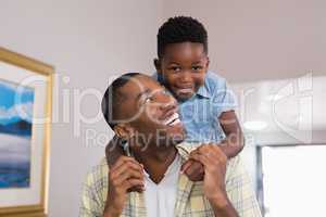 Boy playing with father at home