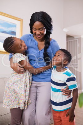 Smiling mother with children in living room