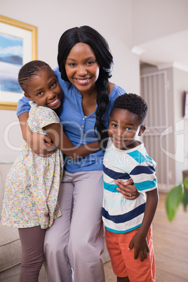 Smiling mother with children at home