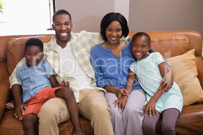 Portrait of happy family sitting on sofa