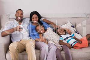 Happy family enjoying television at home