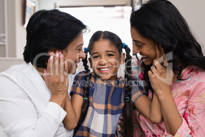 Portrait of cute smiling girl with mother and grandmother