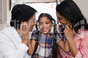 Portrait of cute smiling girl with mother and grandmother