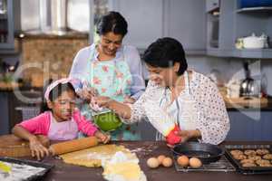 Multi-generation family preparing food together