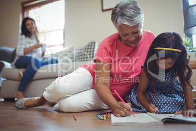 Grandmother and granddaughter coloring book in living