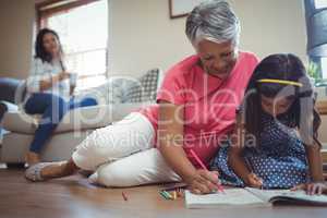 Grandmother and granddaughter coloring book in living
