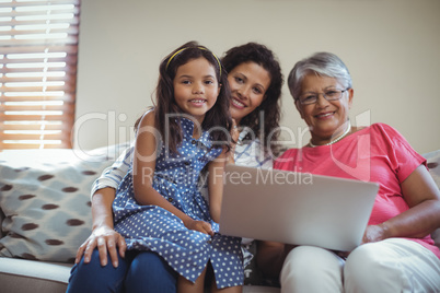 Happy family using laptop in living room