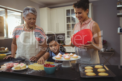 Happy family preparing desserts in kitchen