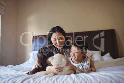 Happy family having fun on bed in bed room