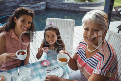 Happy family having tea