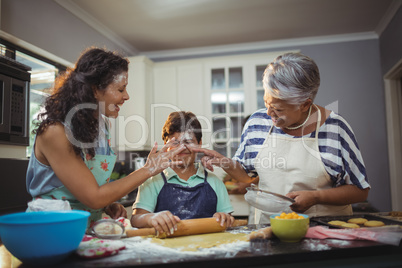 Family preparing dessert in kitchen