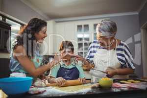 Family preparing dessert in kitchen