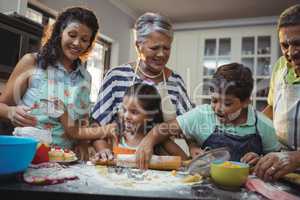 Happy family preparing dessert in kitchen