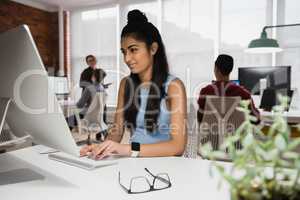 Female executive working on computer in office